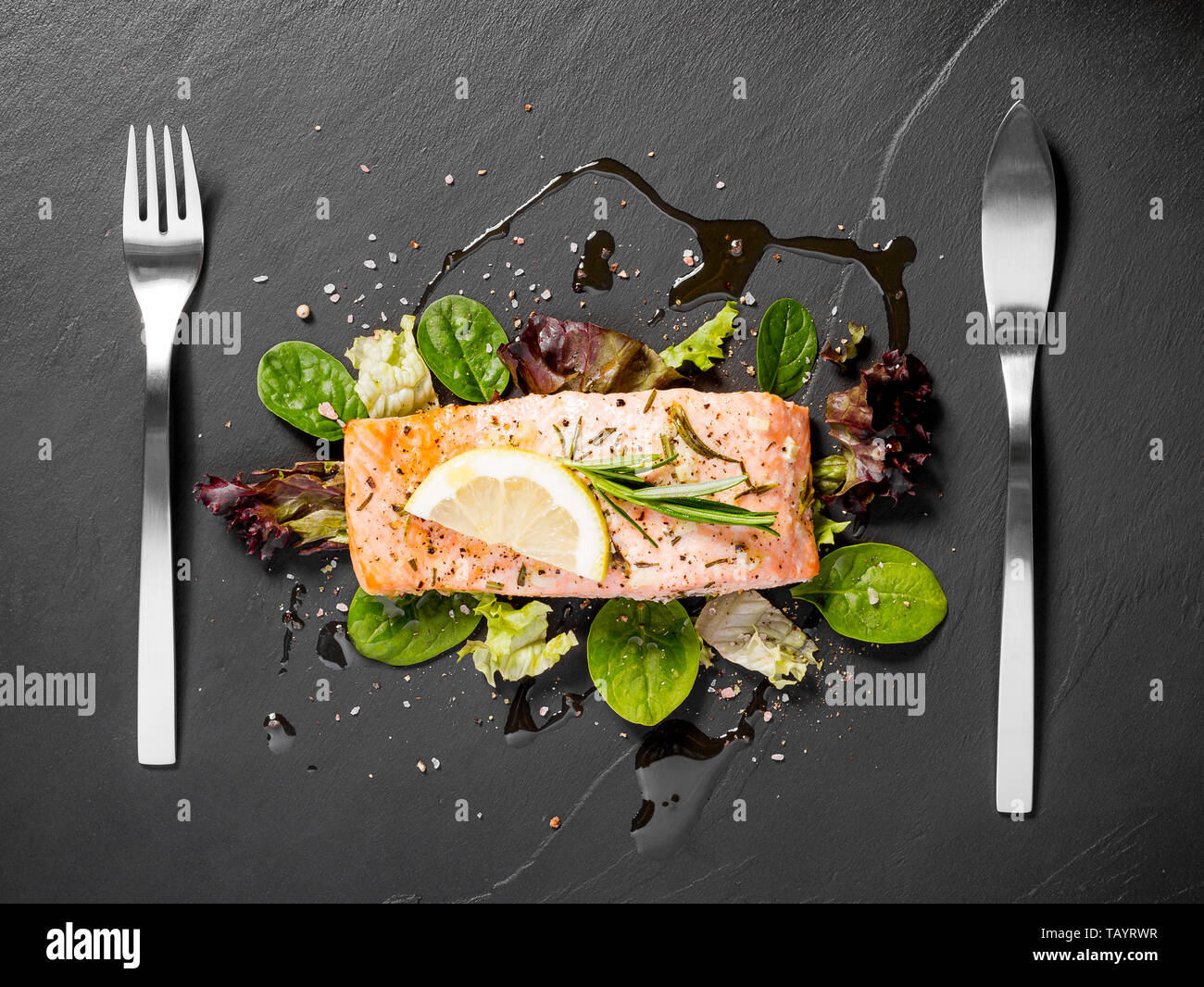 Grilled salmon fillet with salad on black slate plate Stock Photo - Alamy