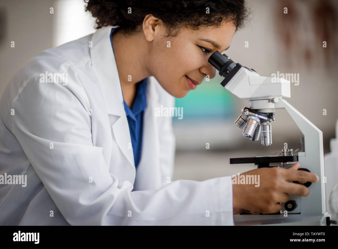 Scientist using a microscope. Stock Photo