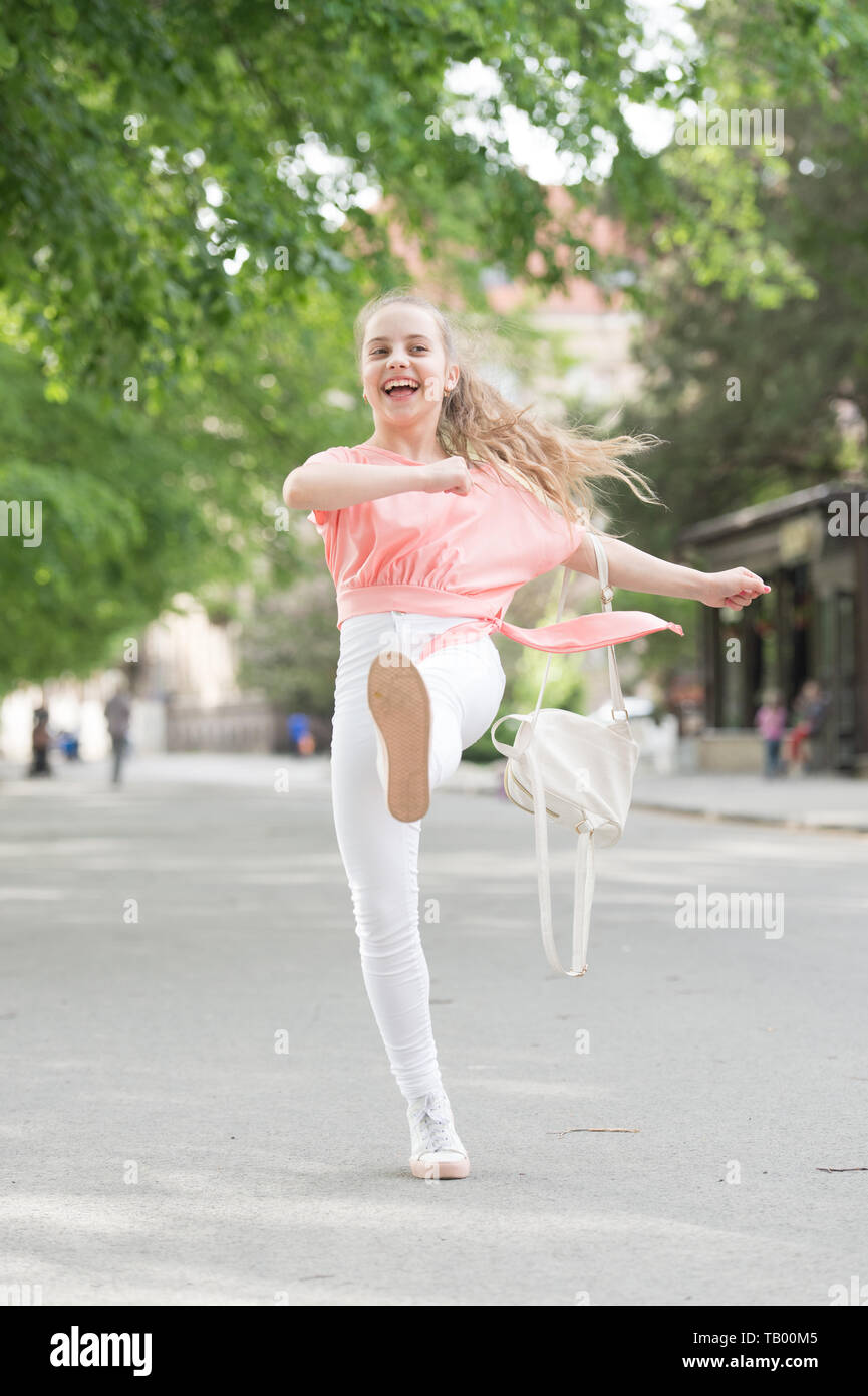Casual look. Happy small girl marching along street in casual and comfy  clothes. Little cute child smiling in casual style. Feeling comfortable in  casual outfit Stock Photo - Alamy