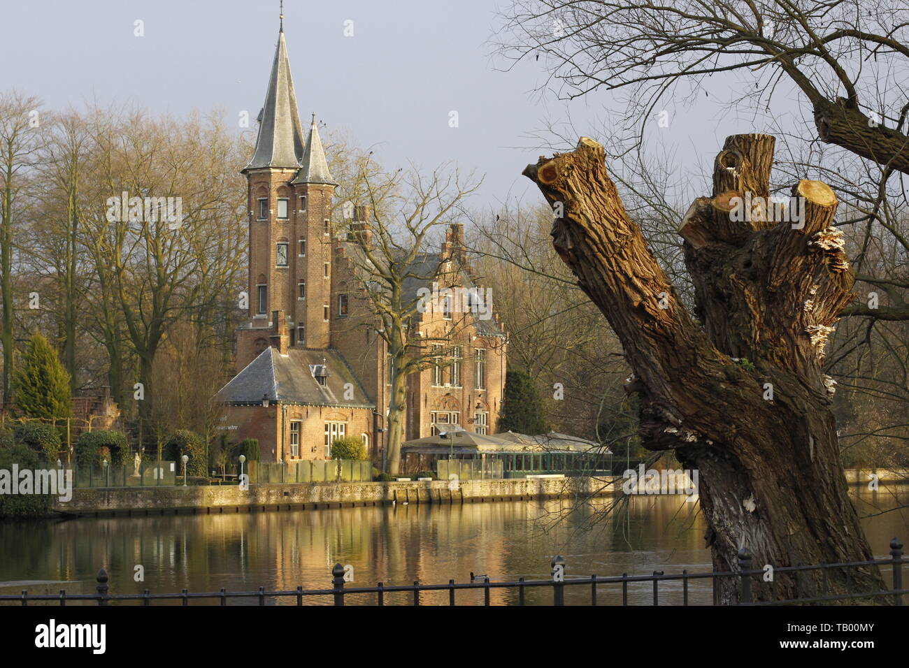 colour image showing a church in Brugge on the opposite bank of a river ...