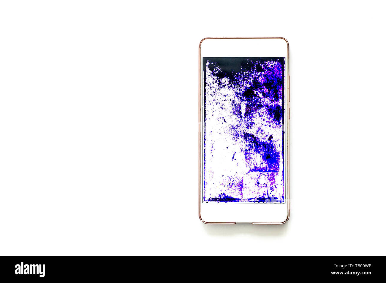 phone with a broken screen on white table. dark spots of purple, blue