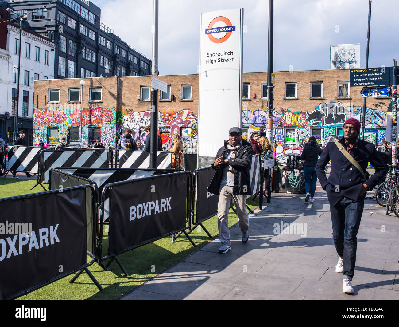 Shoreditch, London, England, UK - April 2019: People walking  near Shoreditch high street station and BOXPARK in Shoreditch East London Stock Photo