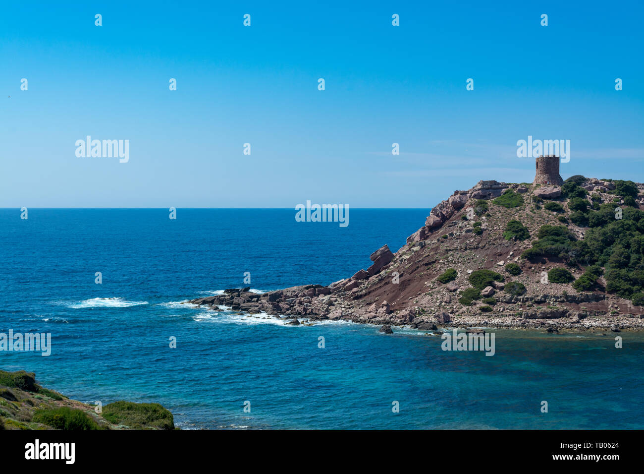 Landscape of the coast near Porticciolo, in Sardinia, with the ancient tower in a sunny day Stock Photo