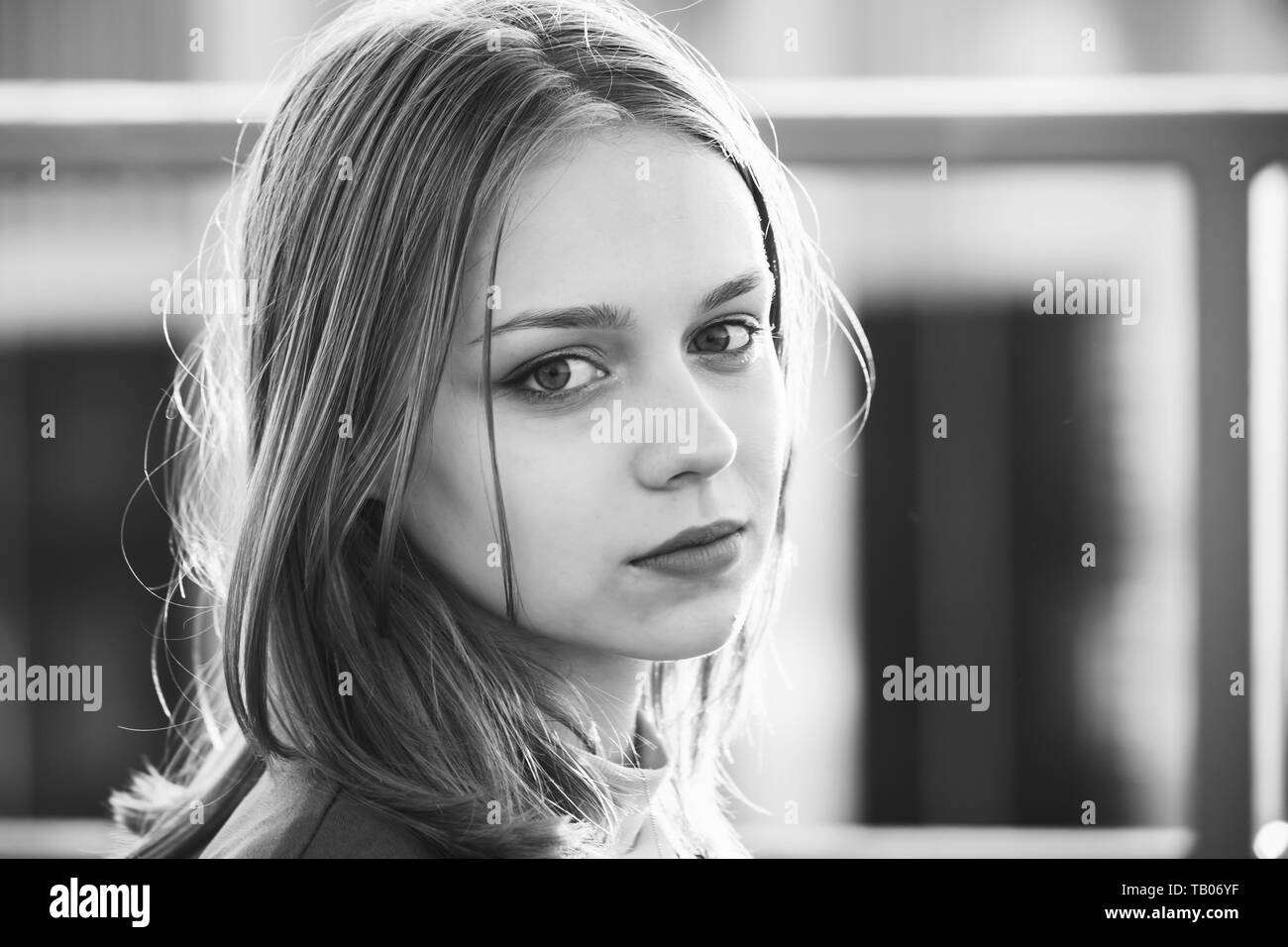 Beautiful blond European teenage girl, black and white close up outdoor portrait Stock Photo