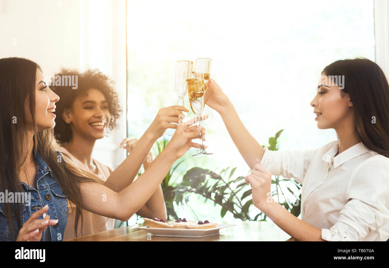 Three best female friends celebrating birthday party and wishing Stock Photo