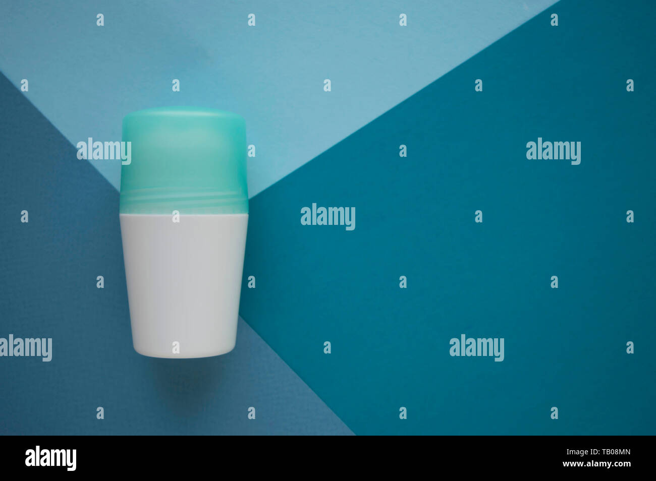 Deodorant or antiperspirant isolated on blue background with copy space