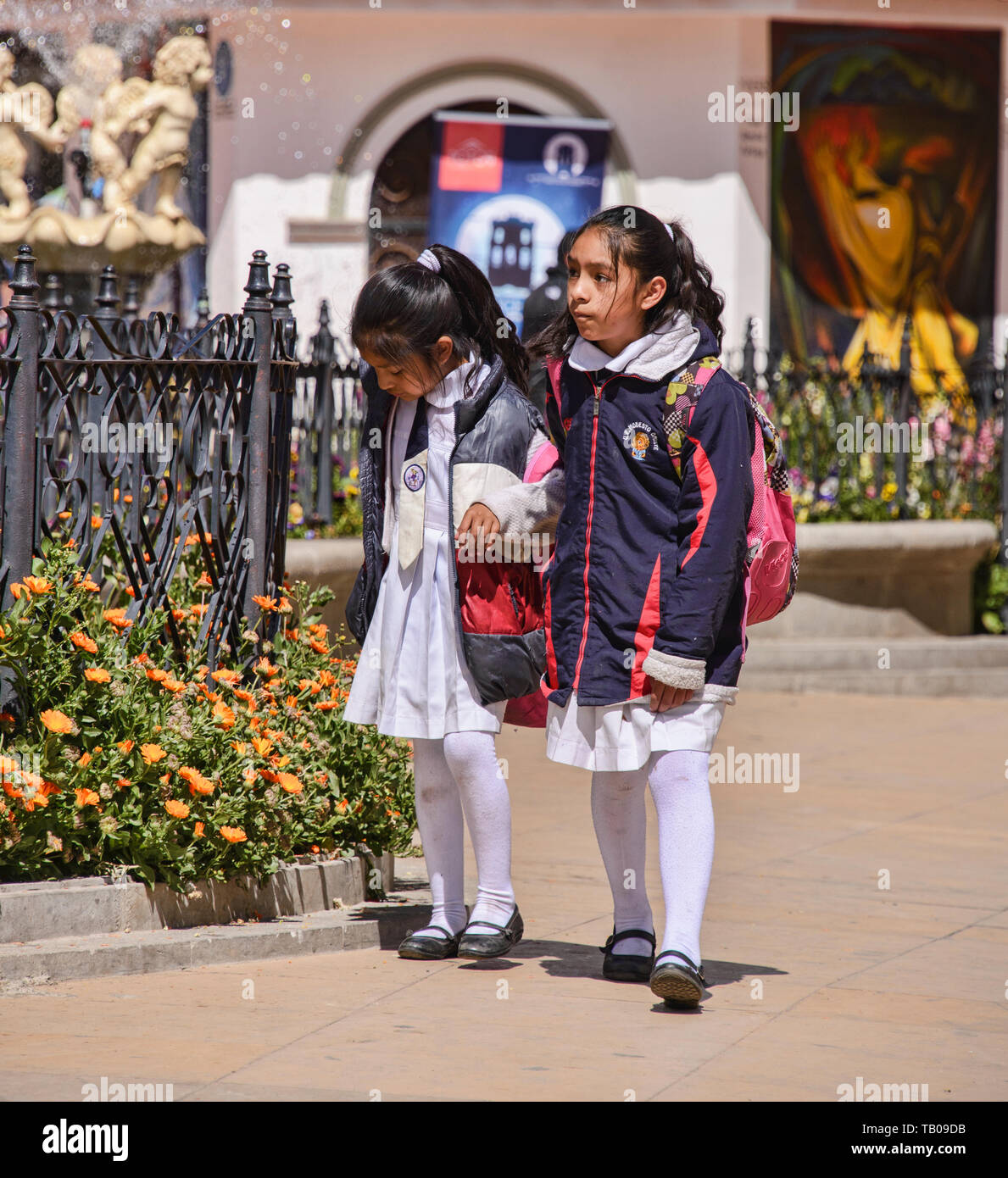 Bolivian kids walking in the Plaza de 10 Noviembre in colonial Potosí ...