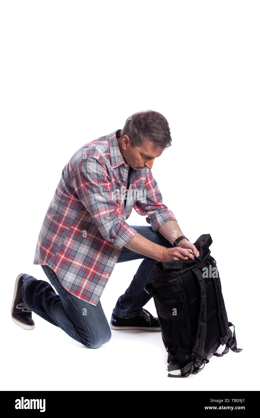 Middle-Aged man preparing a backpack for hiking or trekking. He could also  be a tourist packing hand carry luggage in preparation for a journey Stock  Photo - Alamy