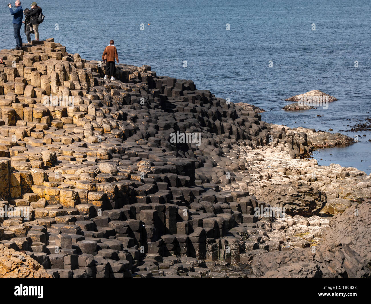 Visitors at Giants Causeway in Northern Ireland - BUSHMILLS. UNITED ...
