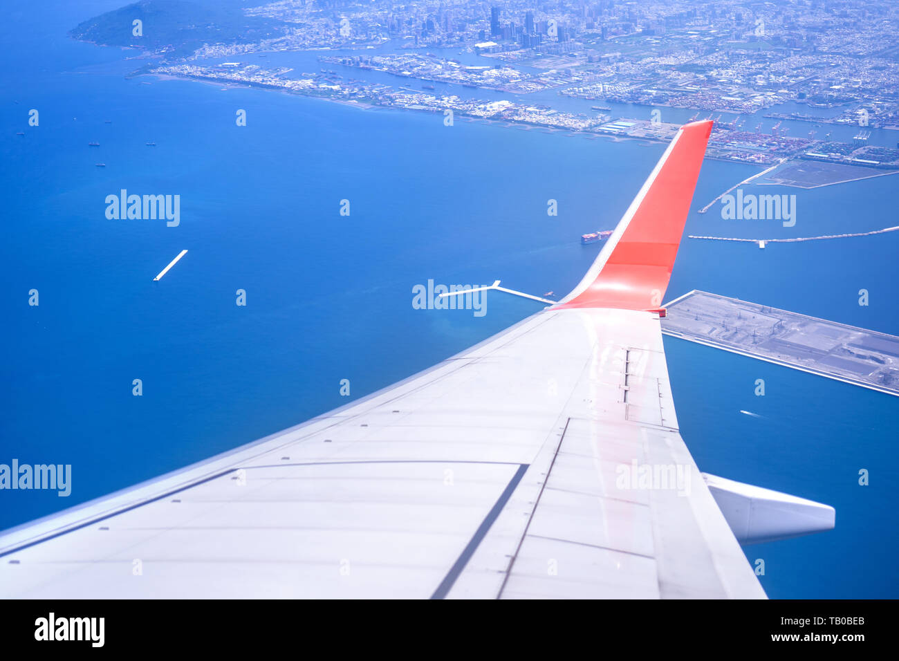 Bussiness and travel concept. Aerial view through window inside aircraft cabin with beautiful blue sky and cloud with sunlight, copy space, top view Stock Photo