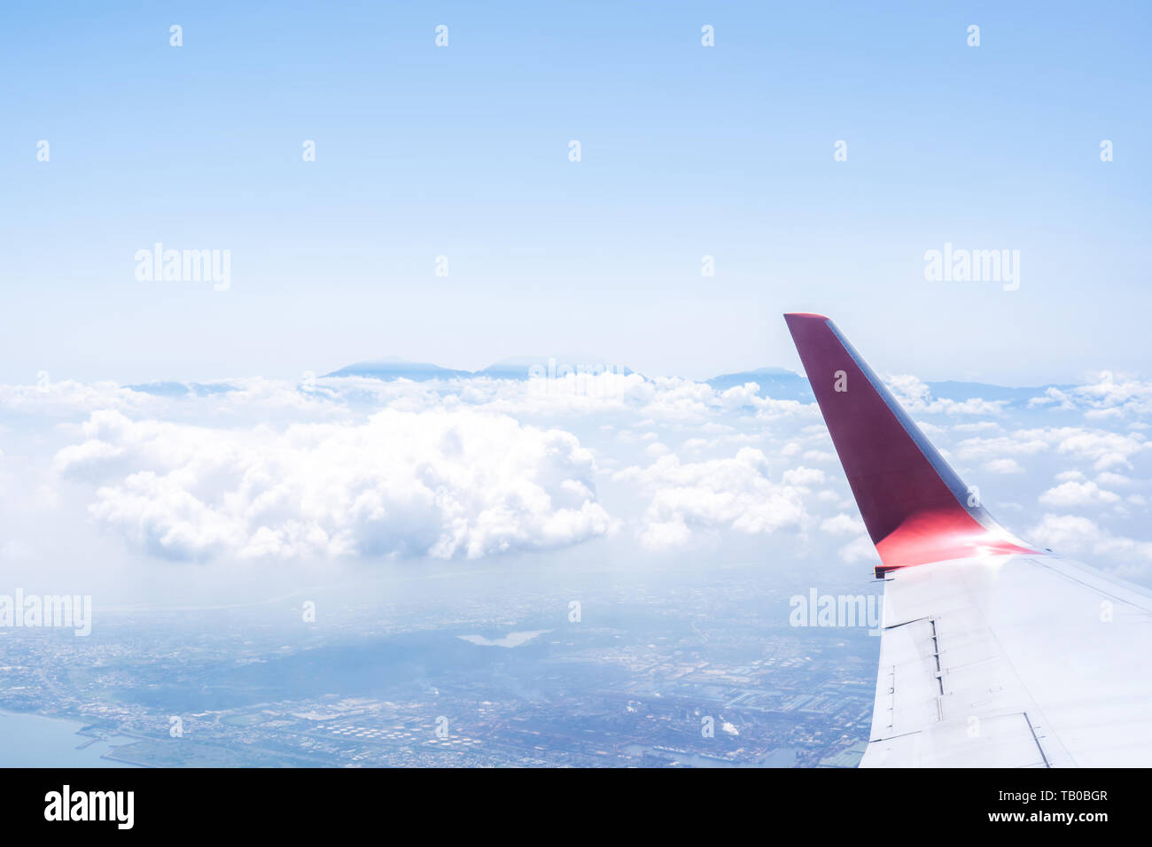 Bussiness and travel concept. Aerial view through window inside aircraft cabin with beautiful blue sky and cloud with sunlight, copy space, top view Stock Photo