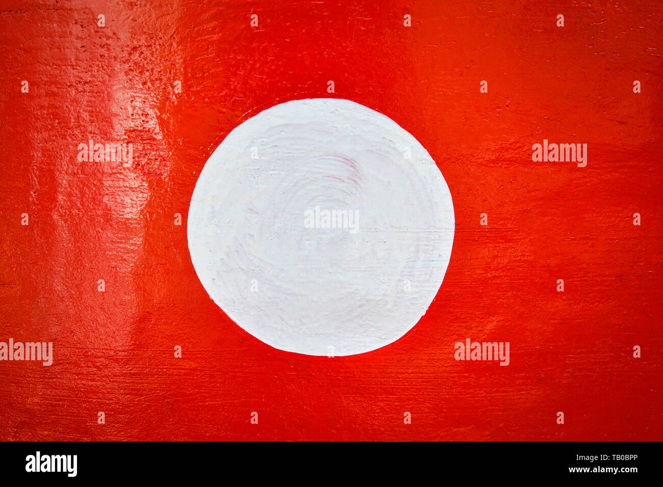 Red background and white circle on center paint on red wall Stock Photo