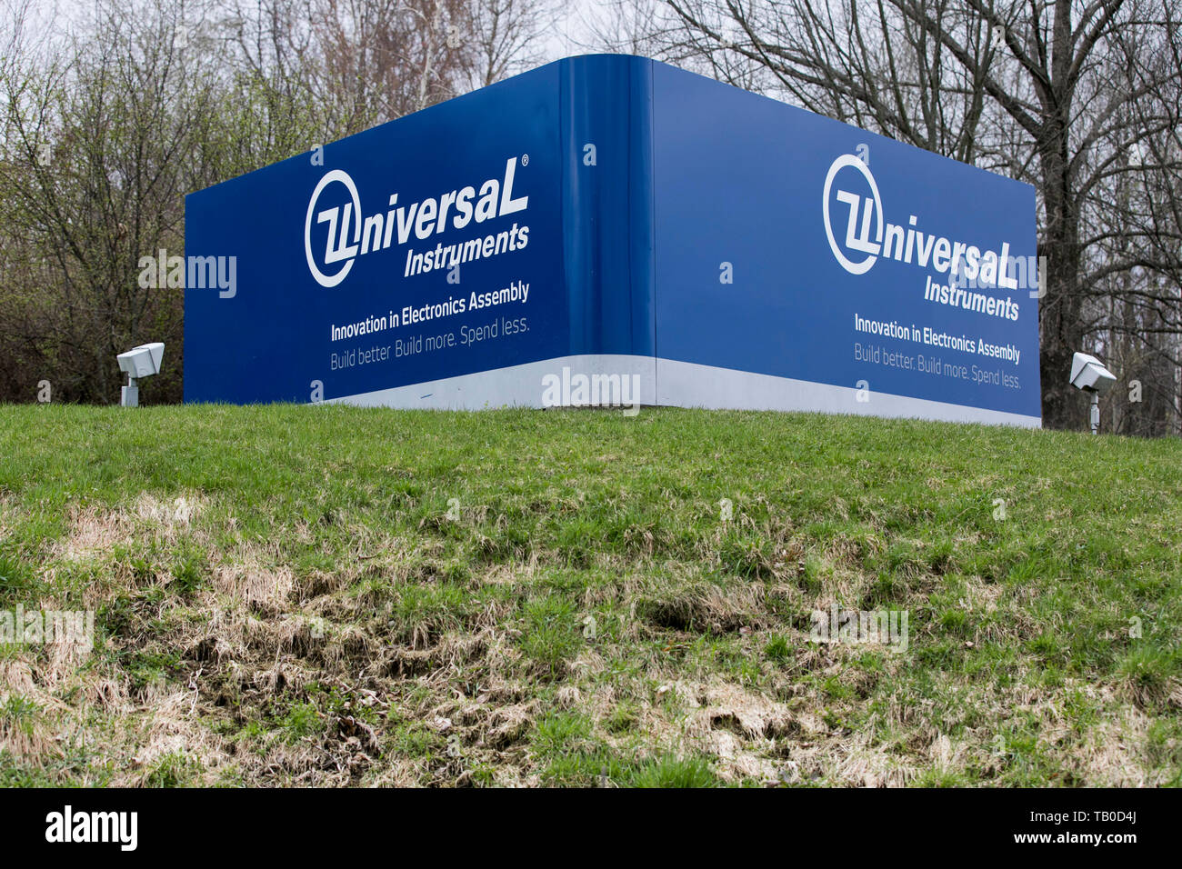 A logo sign outside of the headquarters of Universal Instruments in