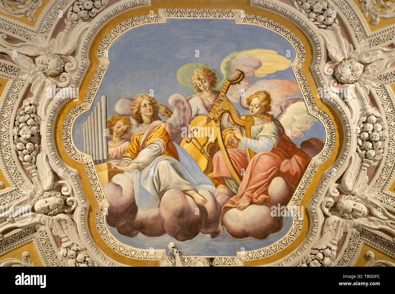 OSSUCCIO, ITALY - MAY 8, 2015: The baroque fresco choir of angels with the music instruments in church Sacro Monte della Beata Vergine del Soccorso Stock Photo