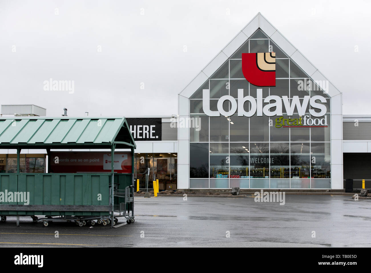 A logo sign outside of a Loblaws retail grocery store location in