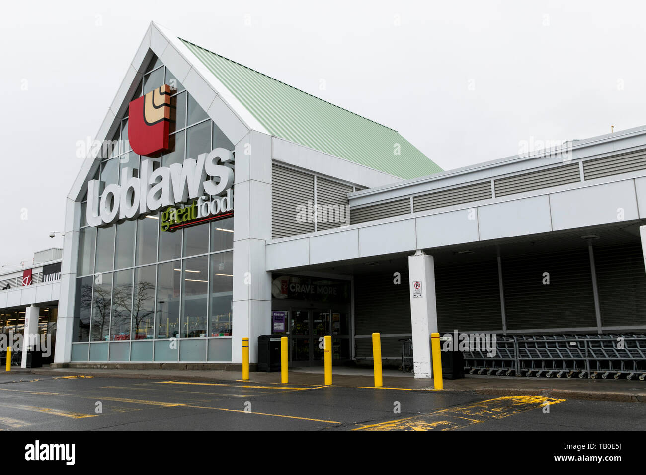 A logo sign outside of a Loblaws retail grocery store location in