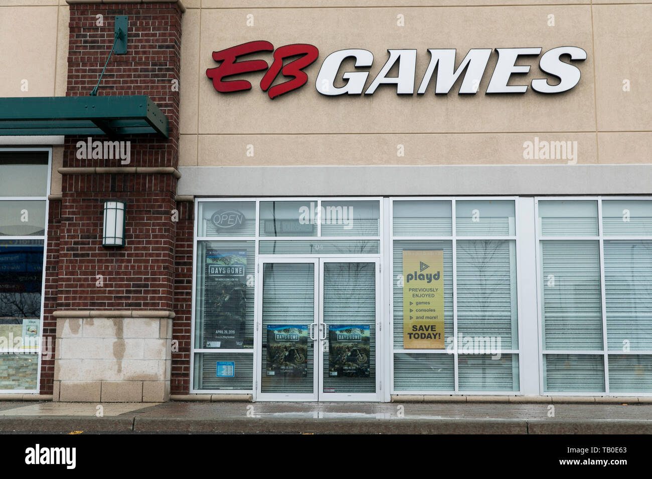 A logo sign outside of a EB Games retail store location in Ottawa, Ontario, Canada, on April 19, 2019. Stock Photo