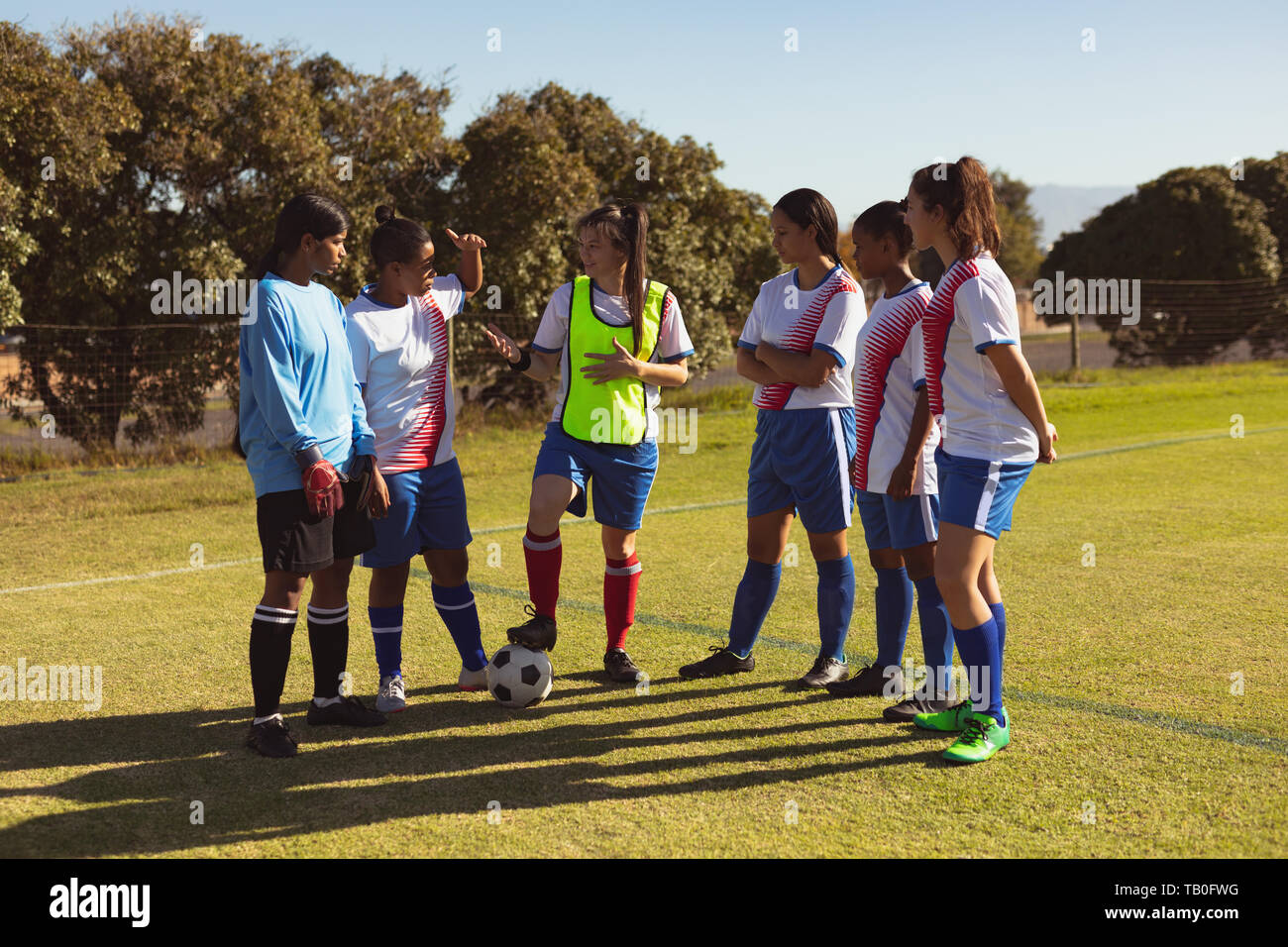 Soccer players interacting with each other at sports field Stock Photo