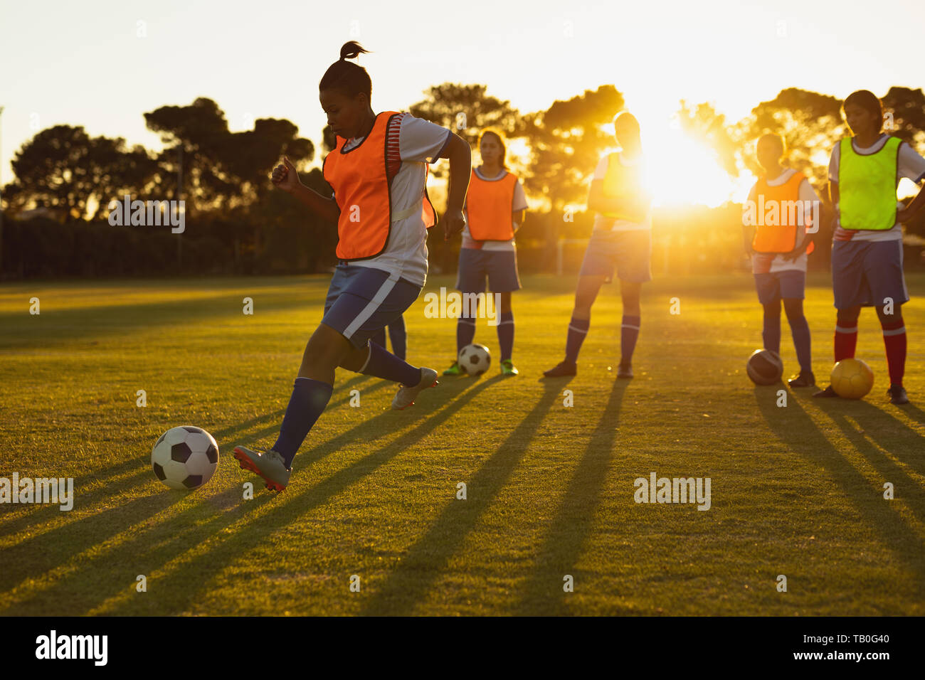 Soccer players playing in sports field Stock Photo