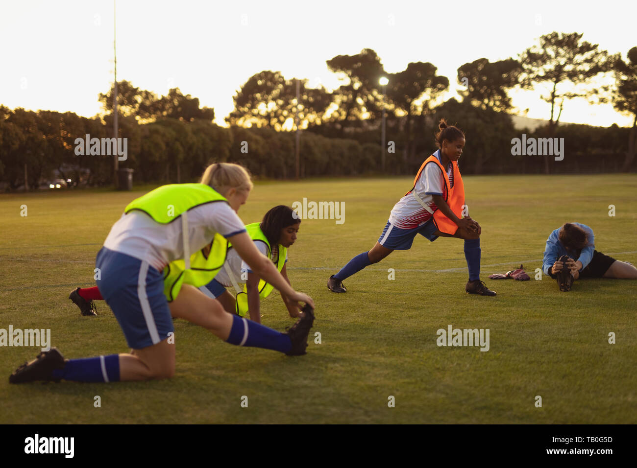 Soccer players doing warmup exercise at sports field Stock Photo Alamy
