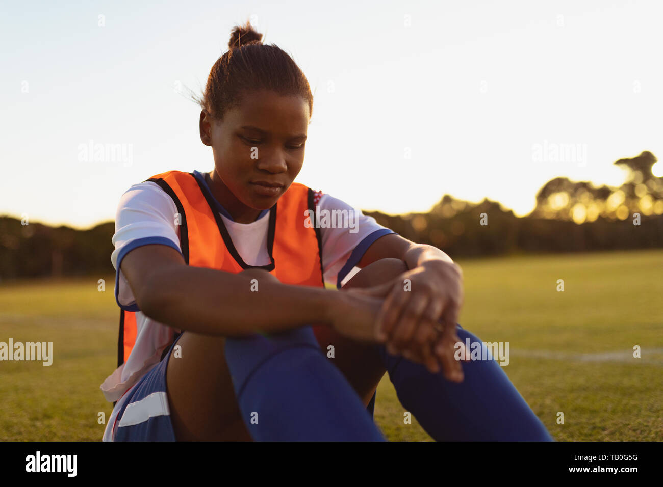 Soccer player relaxing on grass Stock Photo