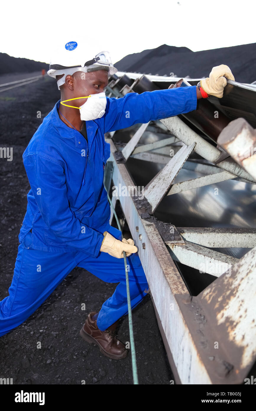 Johannesburg, South Africa April 12 2012 Technician checking conveyor belt at Coal Burning