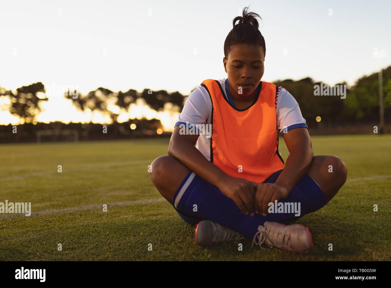 Soccer player relaxing on grass Stock Photo