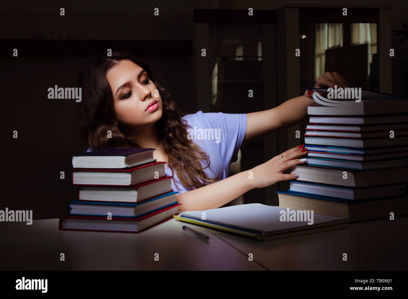 Young female student preparing for exams late at home Stock Photo - Alamy