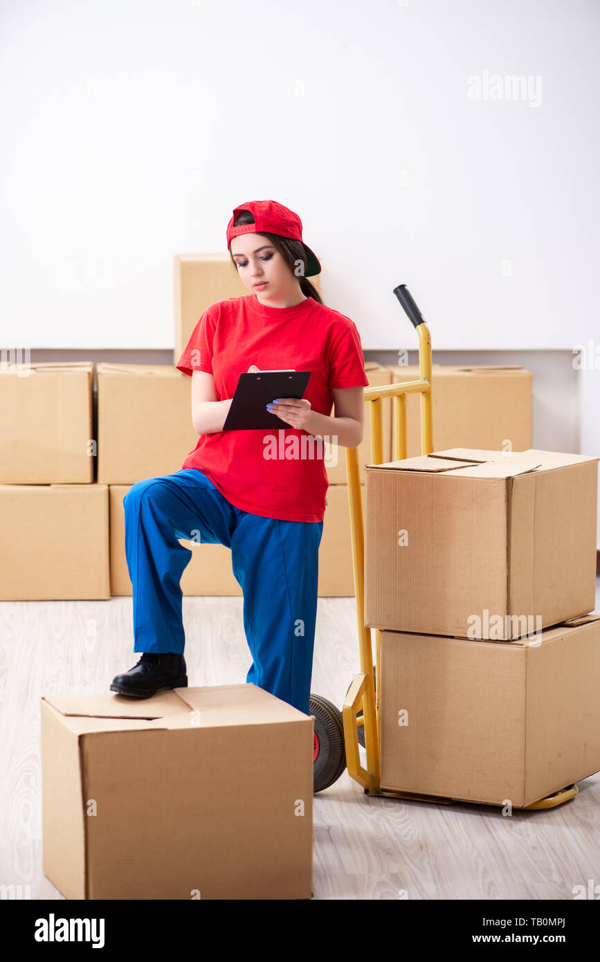 Young female professional mover doing home relocation Stock Photo