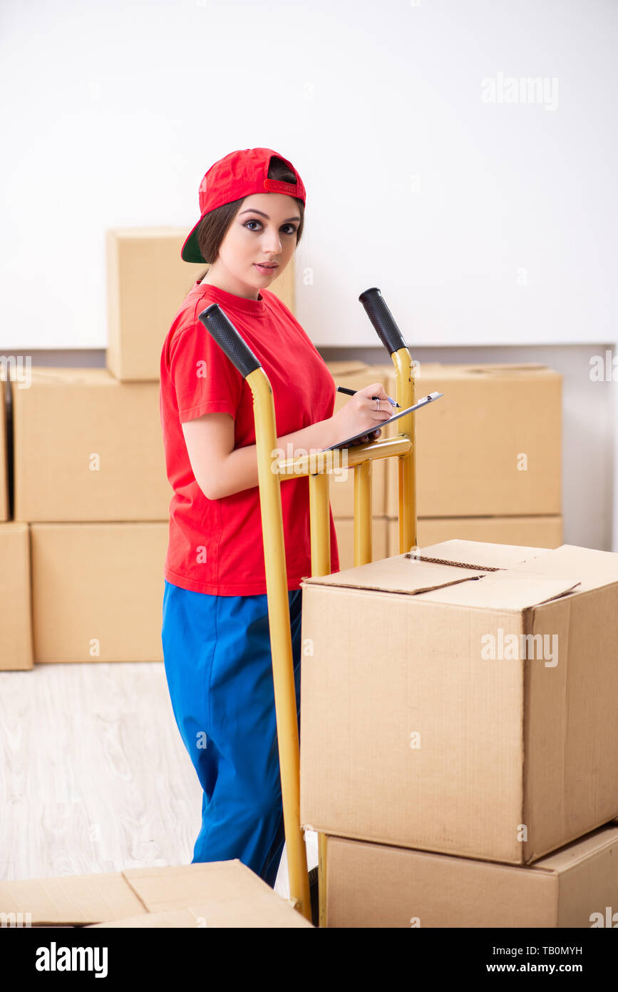 Young female professional mover doing home relocation Stock Photo