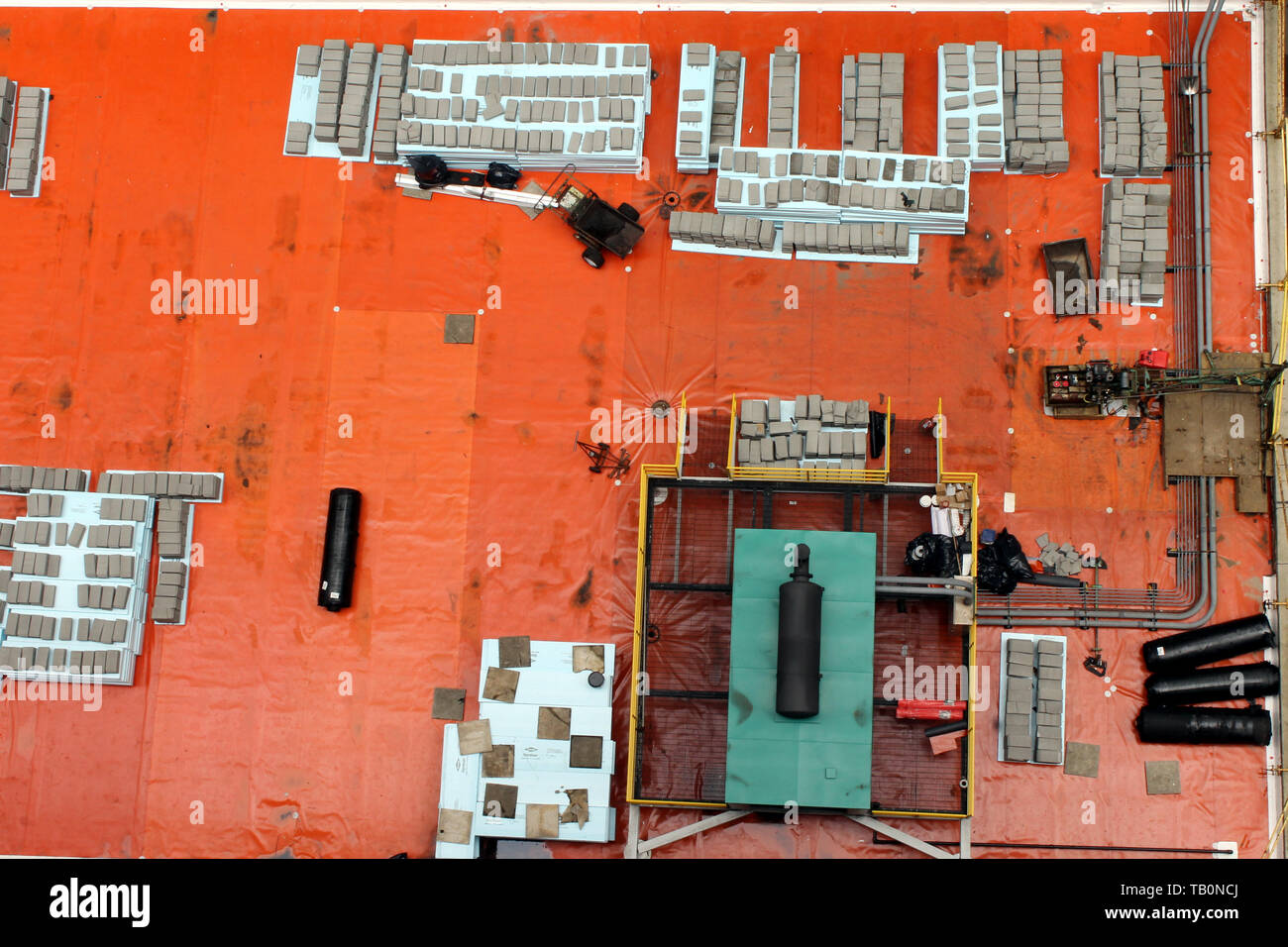 Boxes, pipes and other clutter on the orange roof of a building in downtown Chicago, Illinois USA Stock Photo