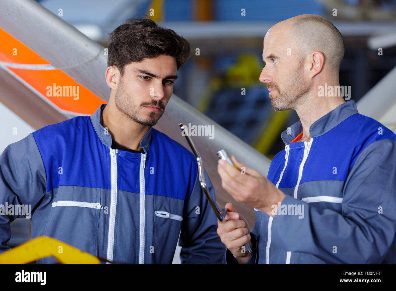 engineers walking in hangar Stock Photo
