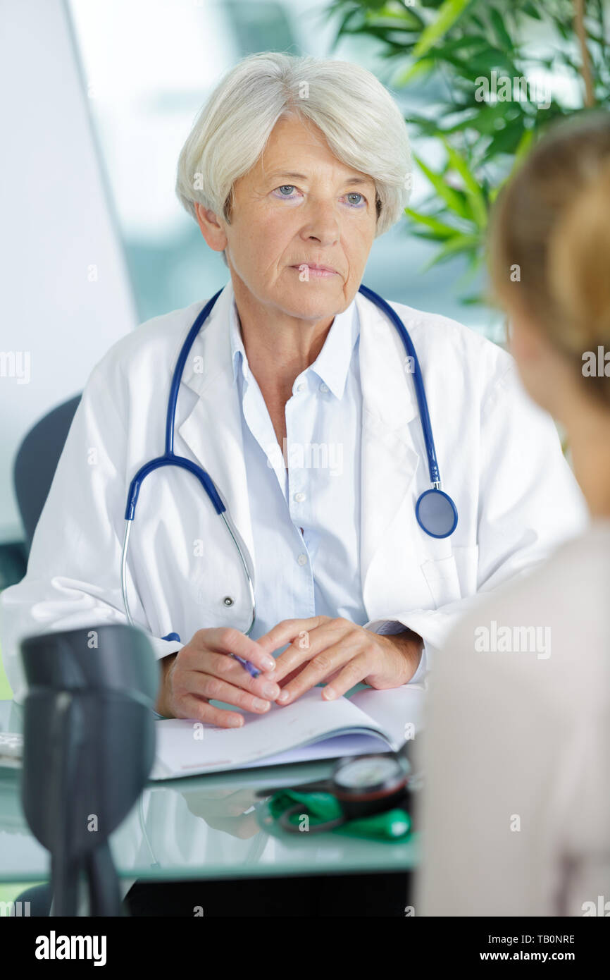 Woman neck pain talking doctor hi-res stock photography and images - Alamy