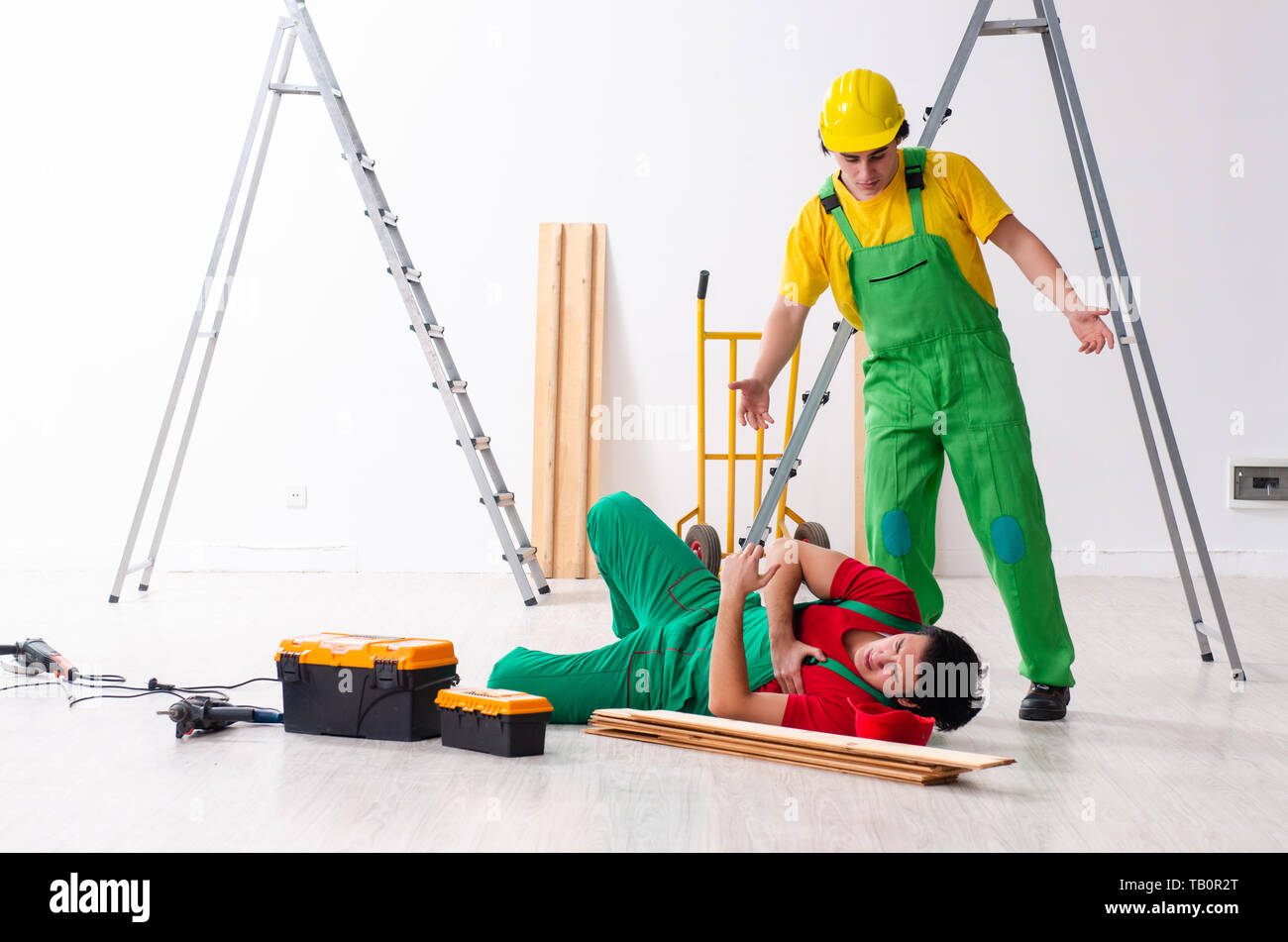 Injured worker and his workmate Stock Photo