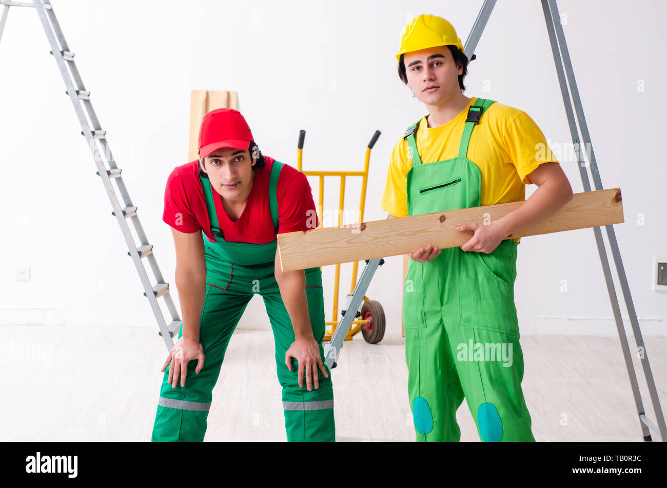 Two workers contractors working indoors Stock Photo