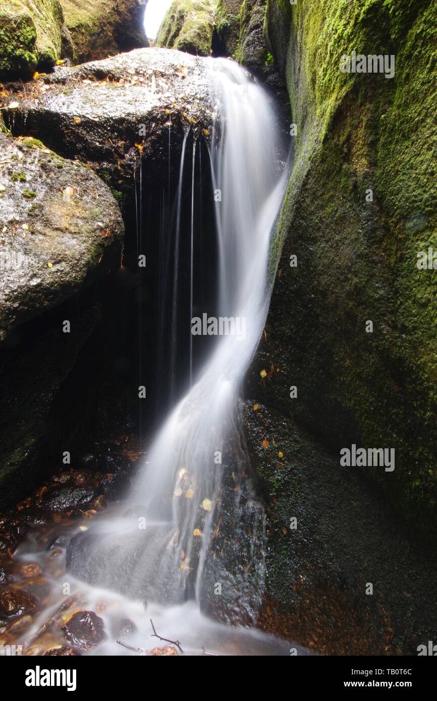 Waterfall at the Burn O'Vat Glacial Pothole on an Autumn Day. Muir of Dinnet NNR, Cairngorms, Scotland, UK. Stock Photo