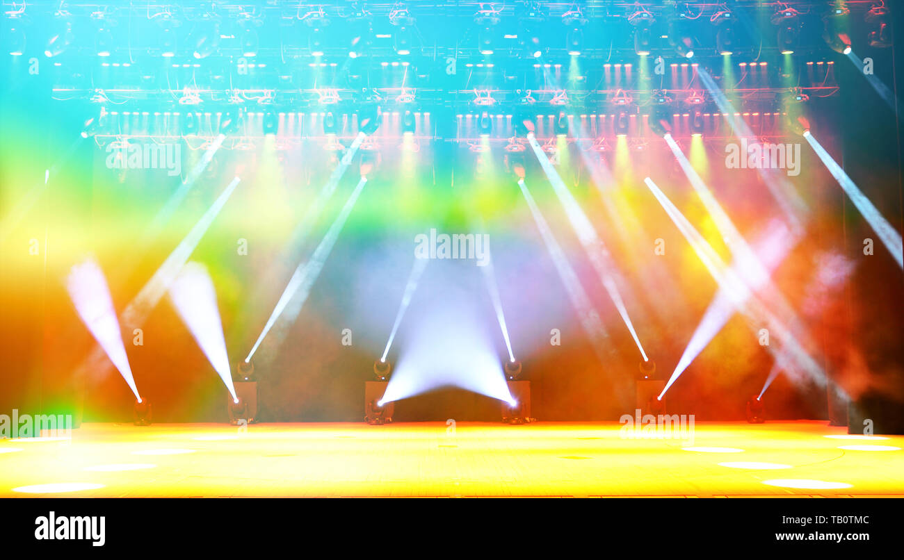 Illuminated empty concert stage with haze and rays of multicolored light.  Background for music show Stock Photo - Alamy