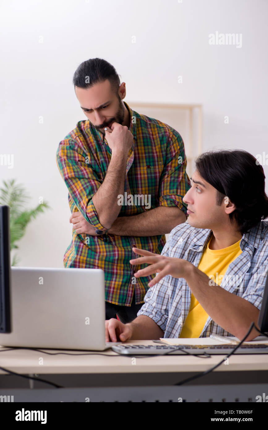 Two it specialists working in the office Stock Photo