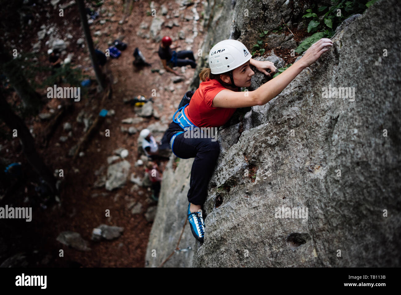 Girl climbing outside with white helmet Stock Photo Alamy