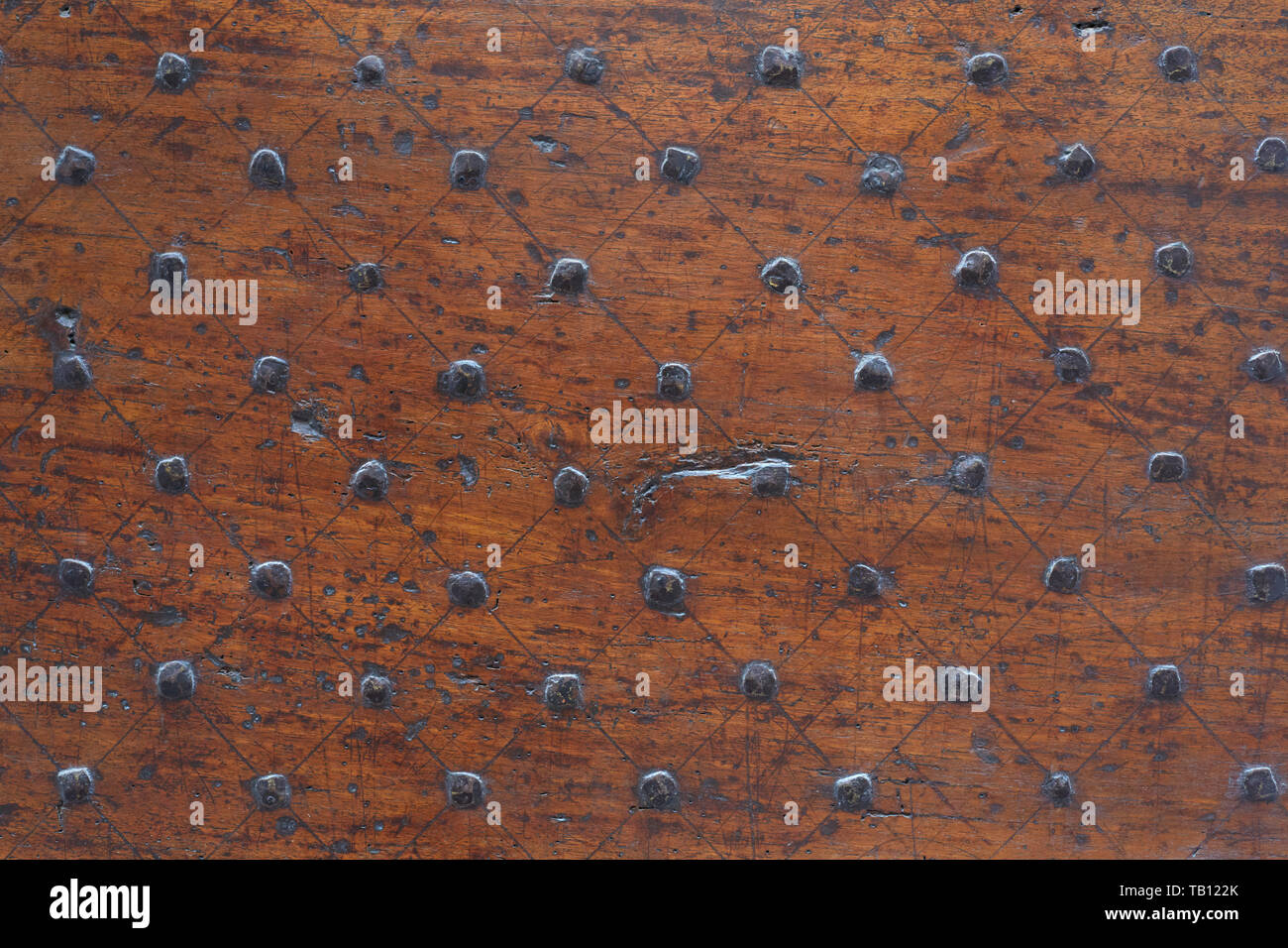 Old wooden door with nails and scratched texture background Stock Photo