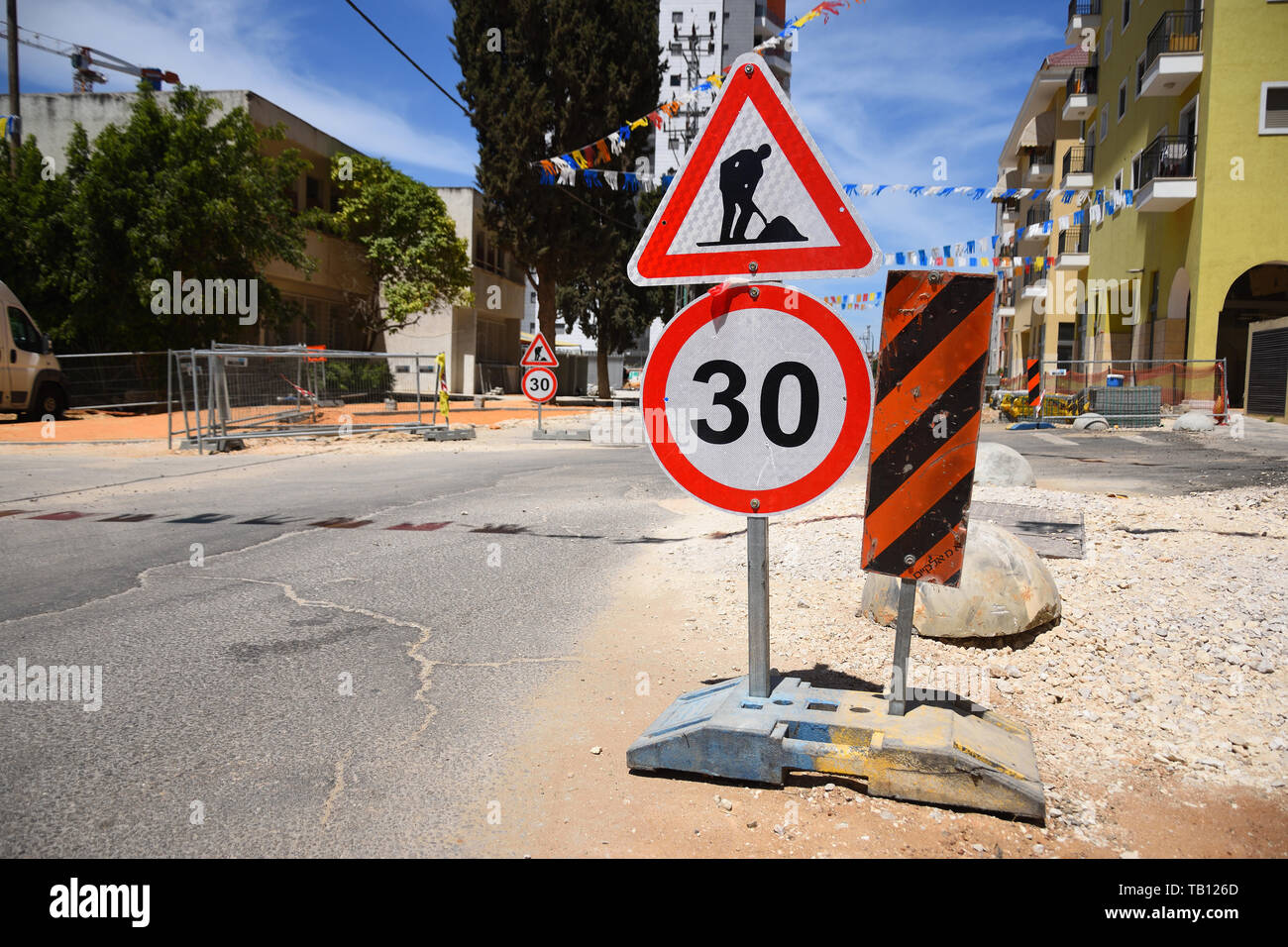Roadwork and speed limit traffic signs in Yehud - small city in central Israel. Stock Photo