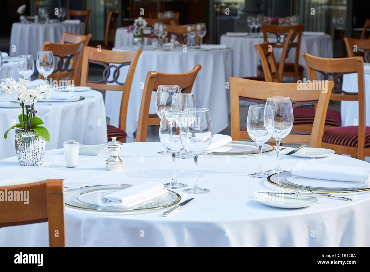 Outdoor elegant restaurant tables and chairs in summer Stock Photo