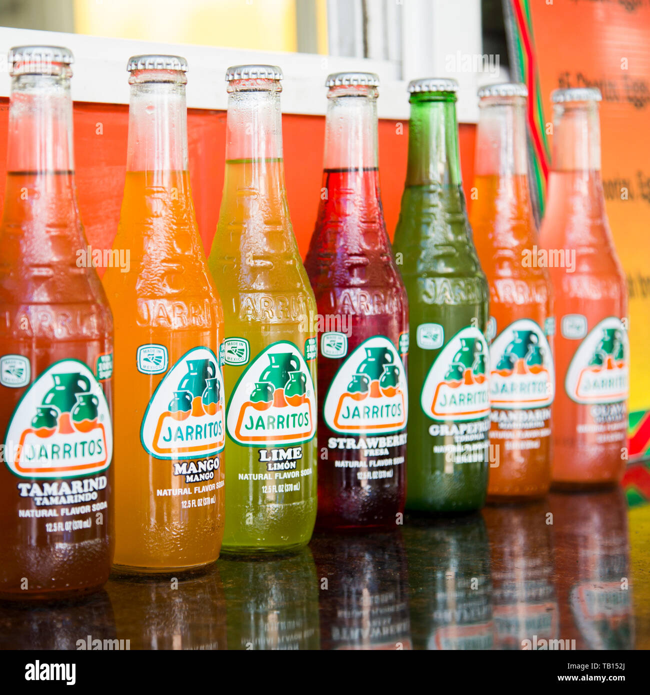 Row of colorful bottles of Jarritos soda for sale at food truck window Stock Photo Alamy