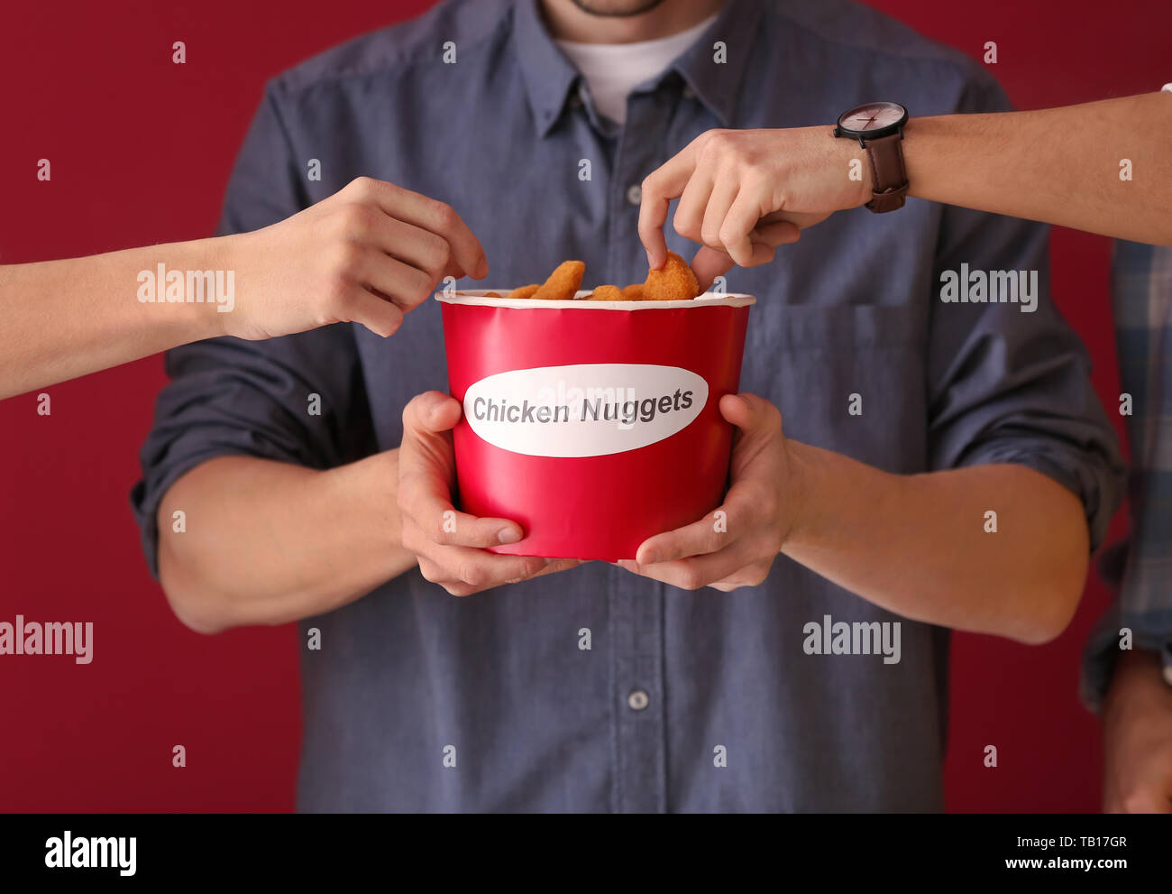 Person eating chicken nuggets hi-res stock photography and images - Alamy