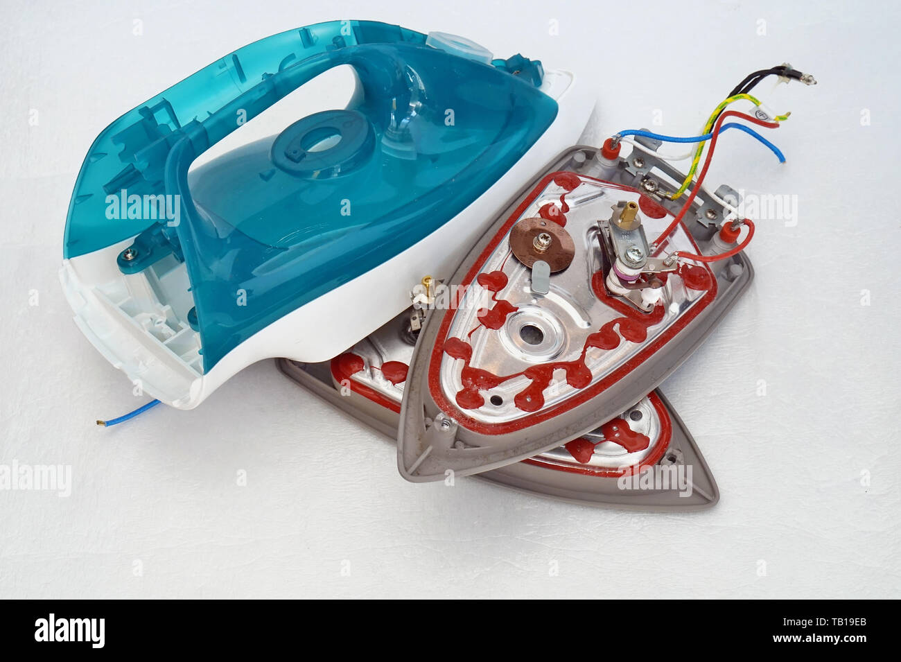 Defective spare parts from modern electric irons are on the table at