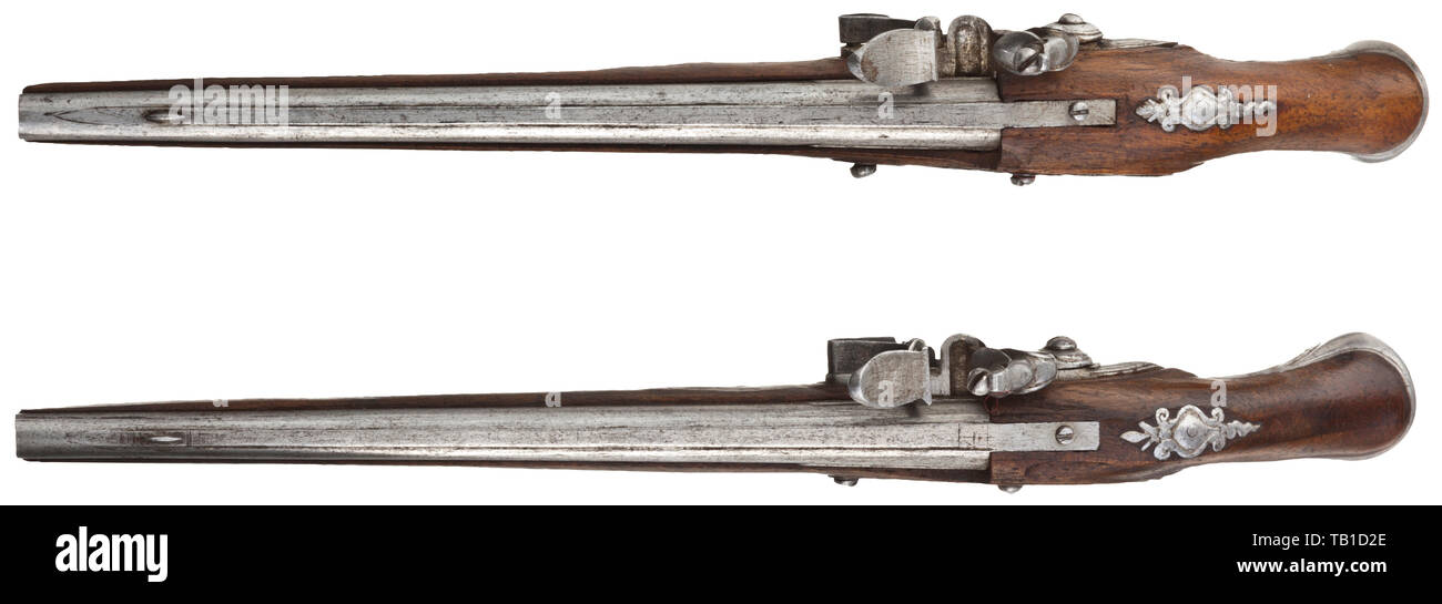 A pair of French miniature pistols, 18th century, Smooth barrels in 3.5 mm calibre with perforated vent holes and distinct barrel rib. Functional, slightly engraved flintlocks. Walnut full stocks with fine openwork side plates and cut iron furniture. Ramrods made of whalebone(?). Length 14 cm. Detailed miniatures of the highest gunsmith quality. miniatures, miniature, small, mini, historic, historical, Additional-Rights-Clearance-Info-Not-Available Stock Photo
