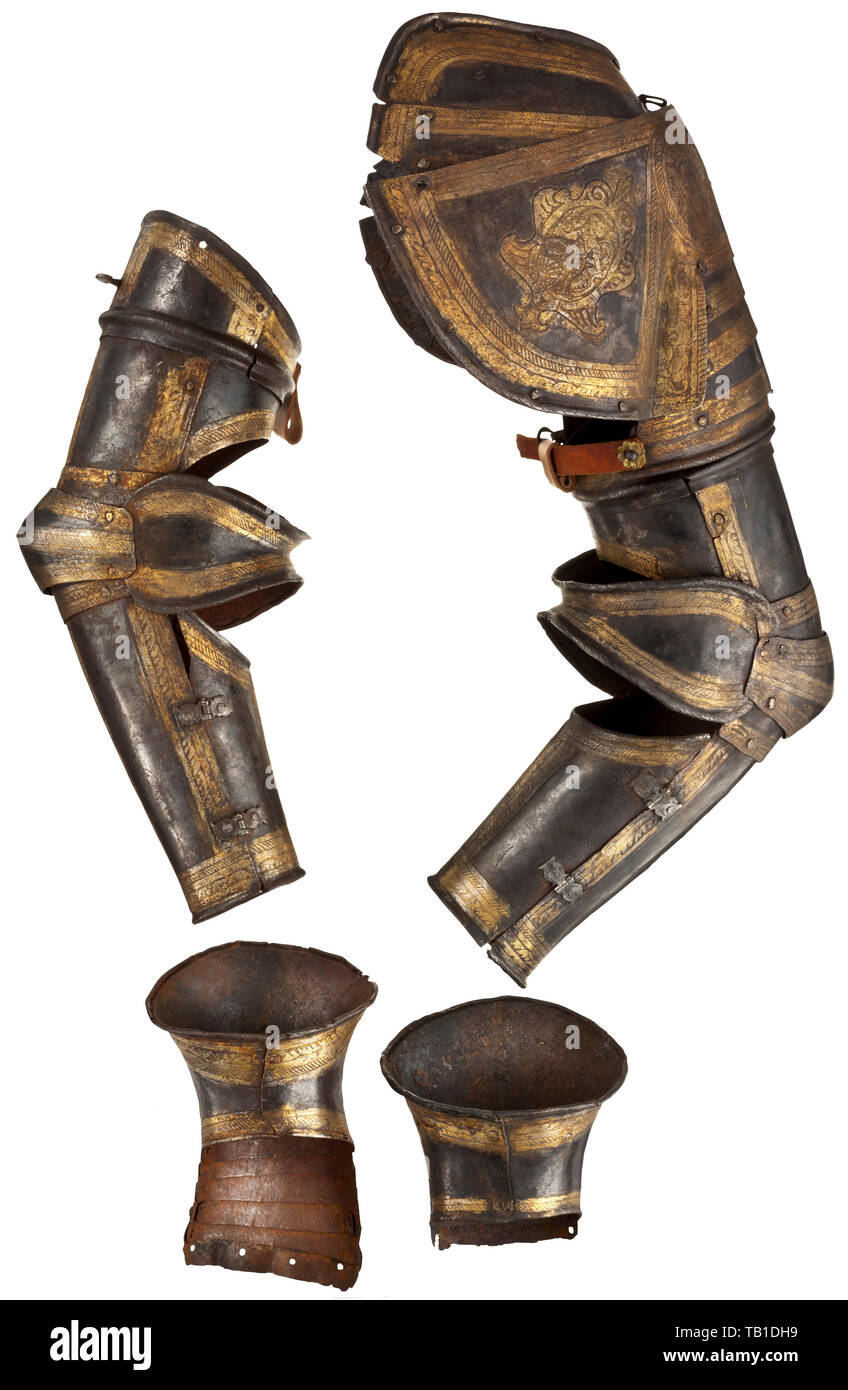 A pair of North Italian etched and gilt arm defences and gauntlets, circa 1580-90, Comprising a full defence for the right arm, with large spaulder of seven lames attached to the turner by a turning-pin on the outer face and by a strap on the inner face, tubular upper-cannon, bracelet couter, and hinged lower-cannon, the defence for the left arm identical but now missing the spaulder, and each with a pair of gauntlets en suite with the arms. etched throughout with cabled bands of trophies, monsters, masks and grotesques on a contrasting stippled , Additional-Rights-Clearance-Info-Not-Available Stock Photo