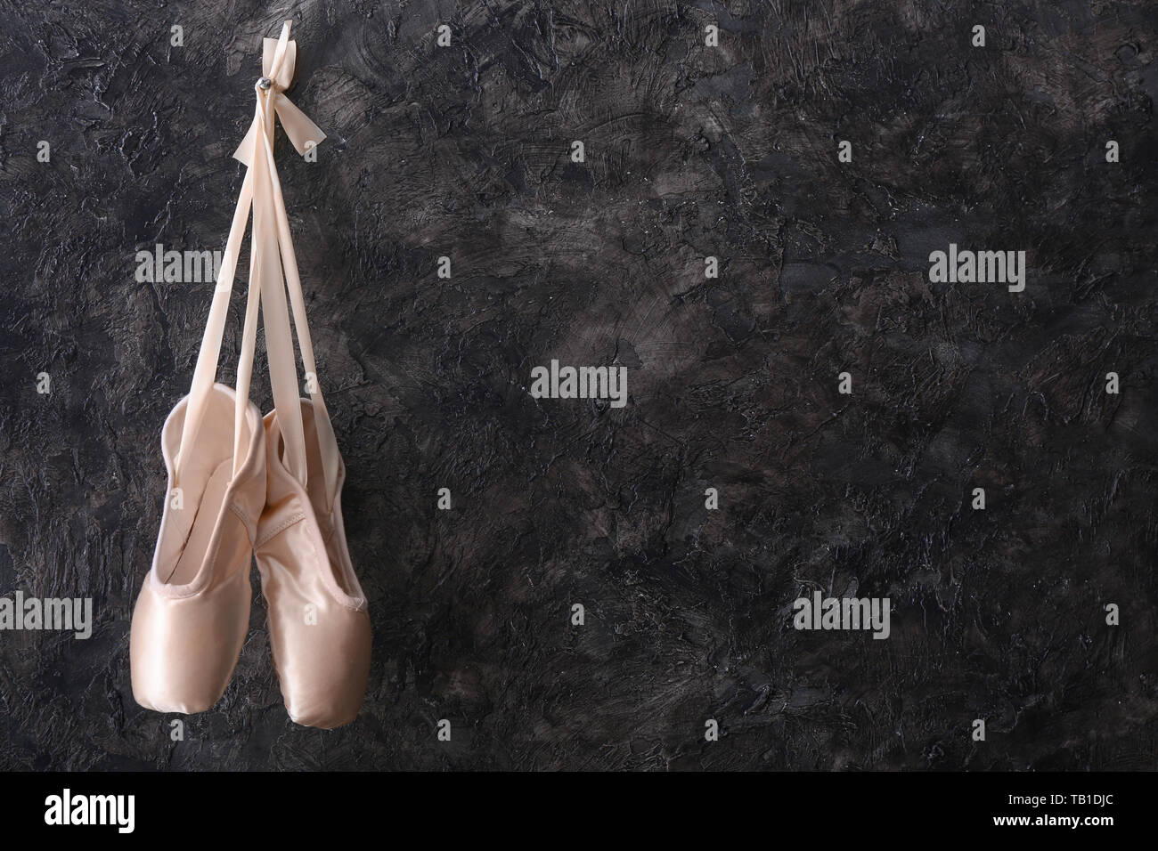 Hanging ballet shoes on dark wall Stock Photo Alamy