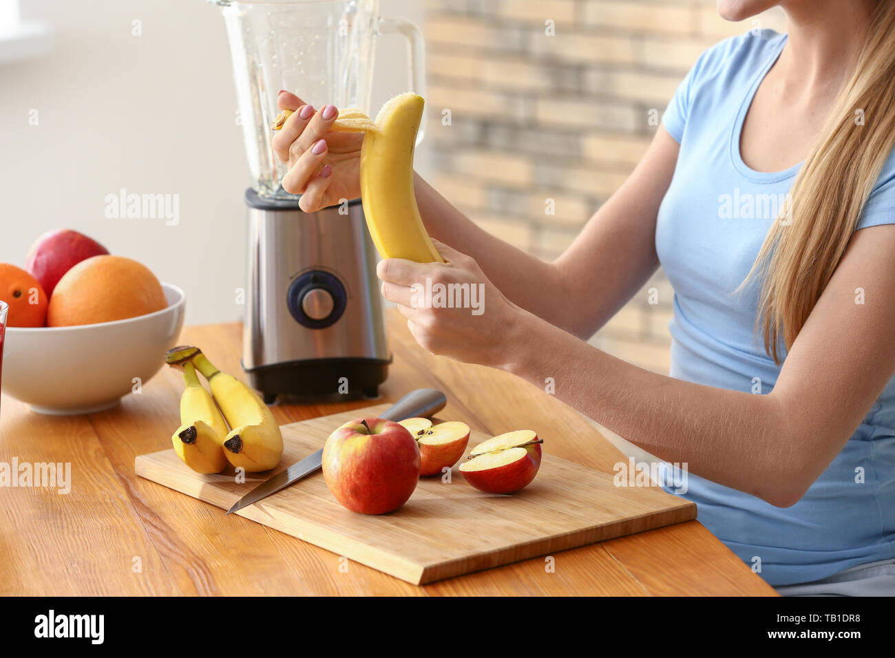 Young woman making healthy smoothie at home Stock Photo Alamy