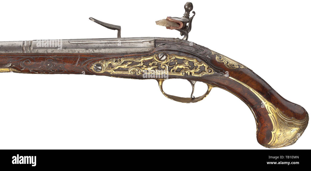 A long flintlock pistol, Felix Meier, Vienna, circa 1730, Two-stage barrel in 16 mm calibre, octagonal then round and smooth after a girdle, with brass front sight. At the breech crowned mark and monogram 'G * B * I * P'. Finely engraved flintlock, the lock plate with horseman motifs and signature 'FELIX MEIER IN WIENN'. Elaborately carved walnut stock (broken and glued at the front and near the lock) with gilt brass furniture decorated in relief and engraved. Replaced wooden ramrod with horn tip. Length 55.5 cm. Felix Meier, Vienna, circa 1672 -, Additional-Rights-Clearance-Info-Not-Available Stock Photo